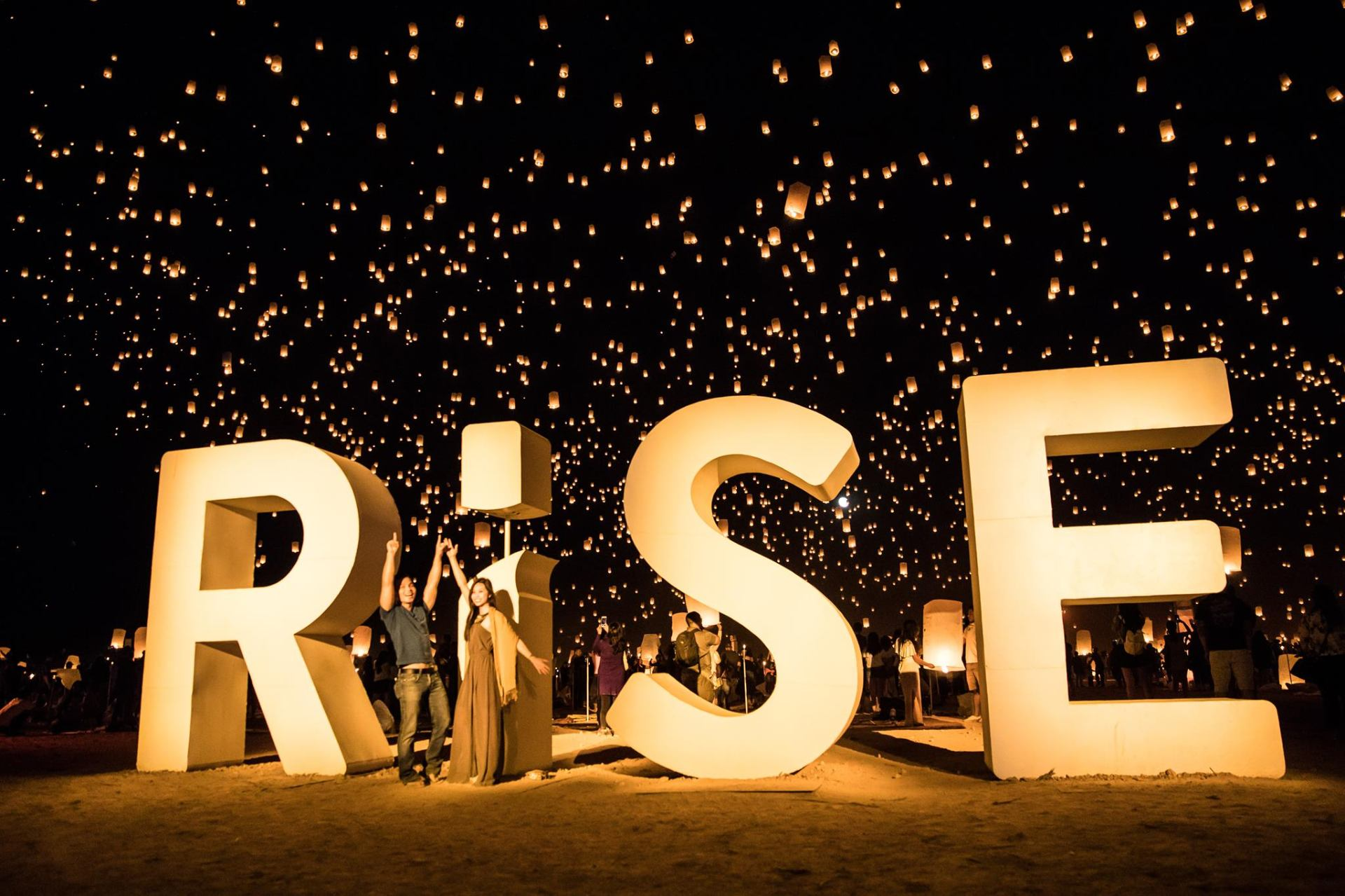 RiSE Festival website with cinematic desert lantern release photography